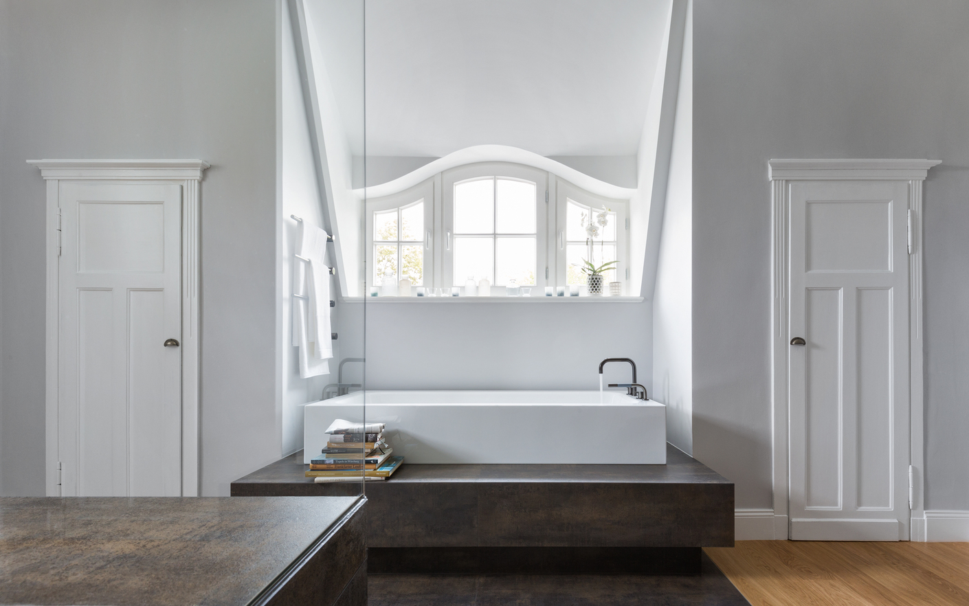 The bathroom is now a bright room which, with its beautiful dormer windows and doors still brings the original building to mind, but is otherwise awash in modern life.