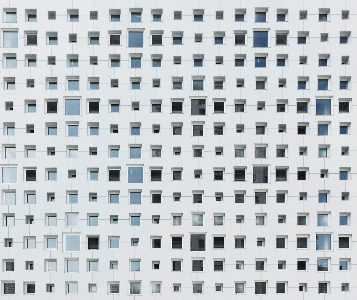 The architects of the new building were inspired by old lace embroidery and patterned wallpaper to create an elegant perforated pattern as a facade.
