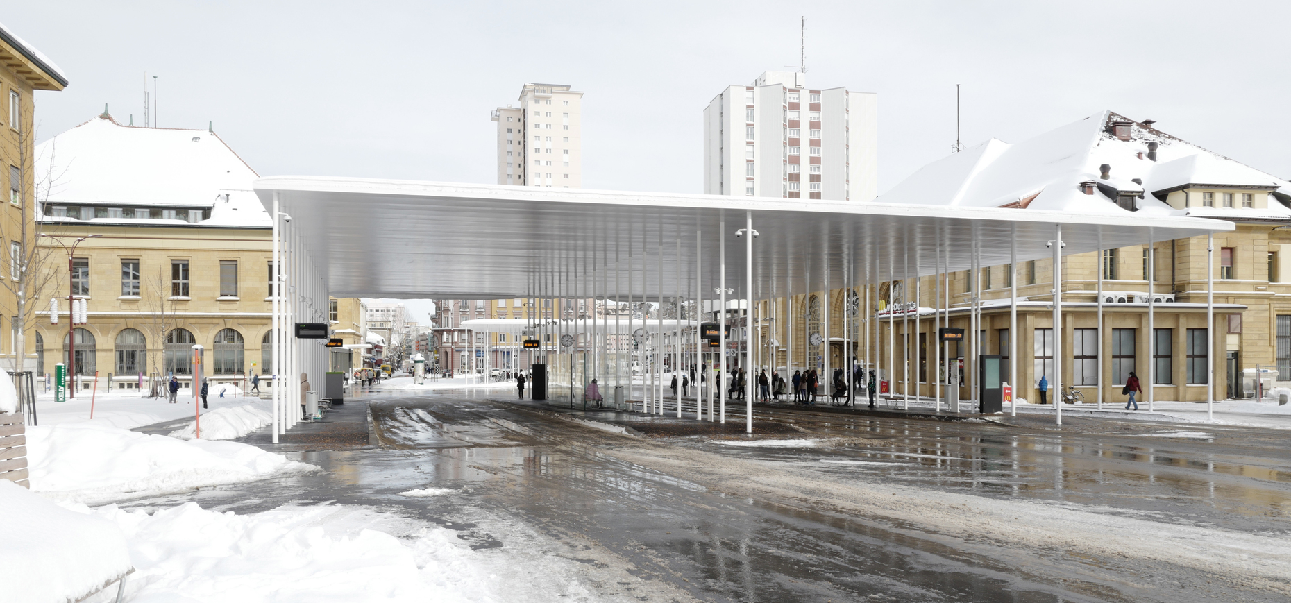 Buses and taxes stop beneath the one roof, while the other is reserved for pedestrians and cyclists.