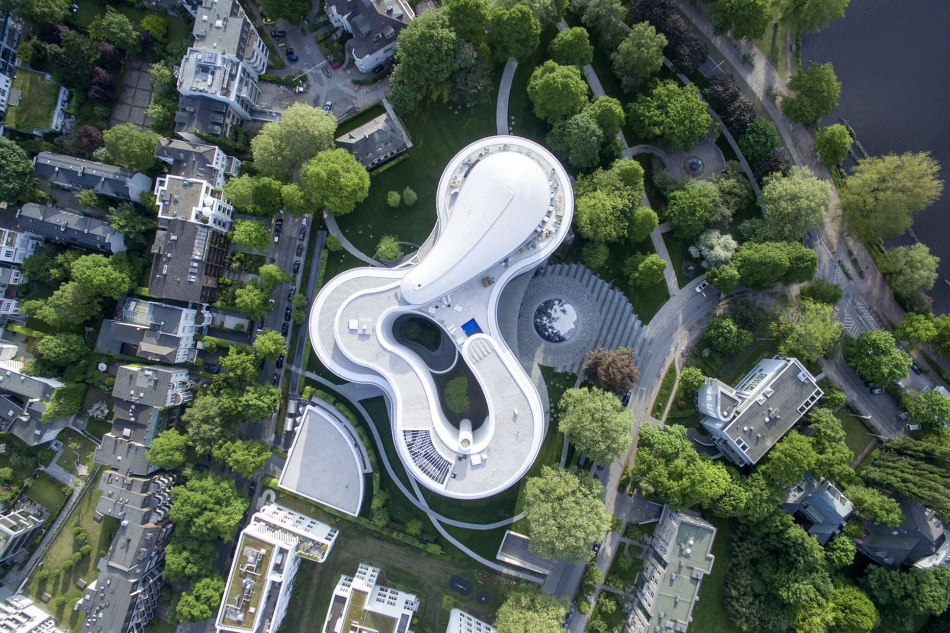 The dynamic architecture combines three interlocking circles, which are clad with white glazed ceramic plates.