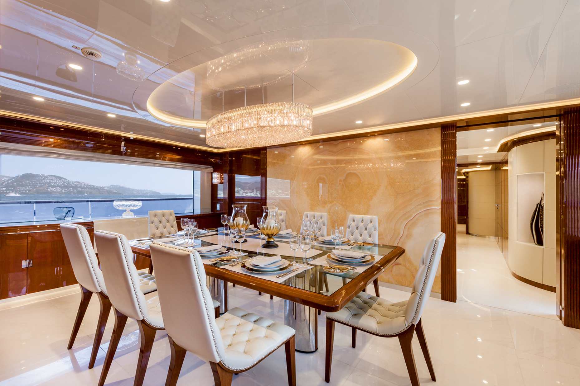 Another Swarovski model graces the dining room area: a large compact oval suspension luminaire with a multitude of crystals set closely together.