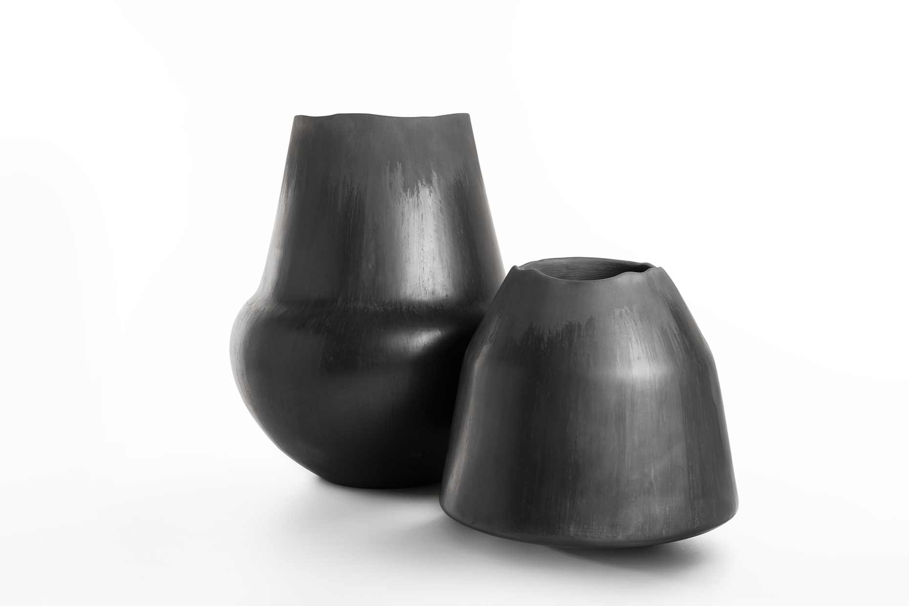 Two "Buccheri" vases by Roberto Sironi, carved from wood and then charred in a controlled process.