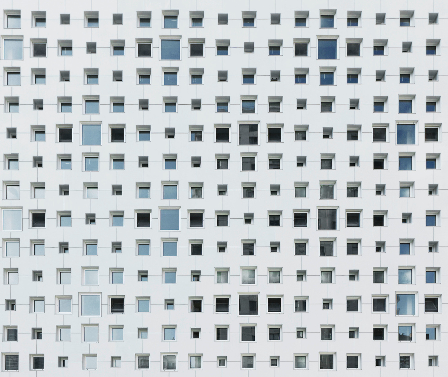 The architects of the new building were inspired by old lace embroidery and patterned wallpaper to create an elegant perforated pattern as a facade.