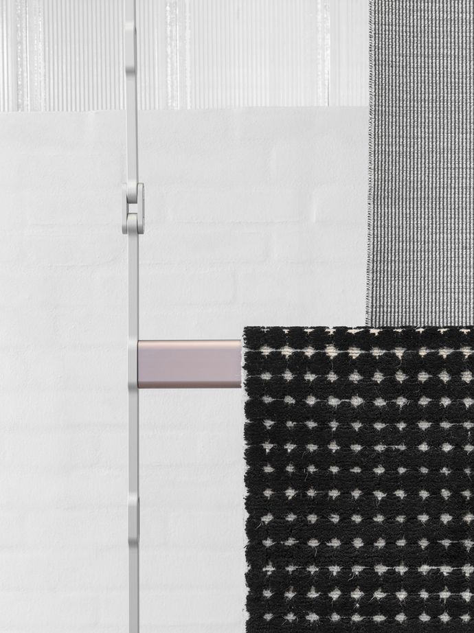 For the presenting of large swathes of material and rugs the Bouroullecs came up with heavy-duty shelving and a suspension system consisting of anodized aluminum sections and height-adjustable rails.