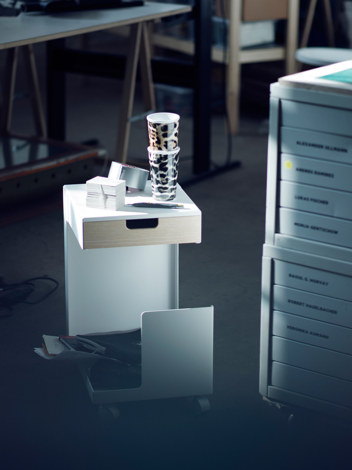 The roll container "Ed" is folded from a piece of steel sheet and also serves as a seat.