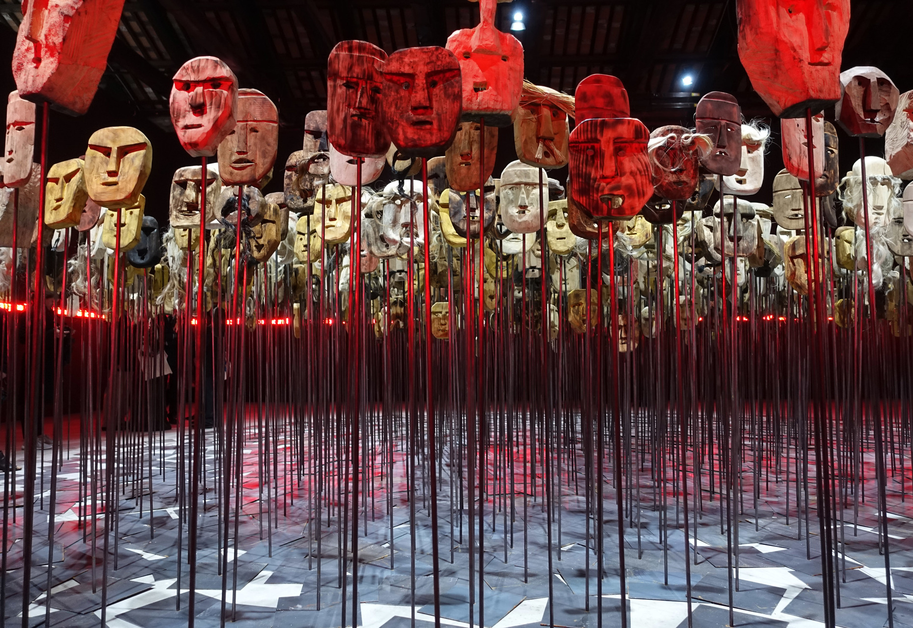 Preventing the public extinction of history: In the Chilean Pavilion, Bernardo Oyarzún presents 1,500 masks surrounded by a luminescent strip with 6,906 Mapuche names.